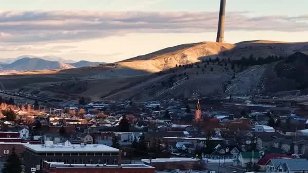 Anaconda spreads across the valley beneath snowy hills and its historic smelter stack.