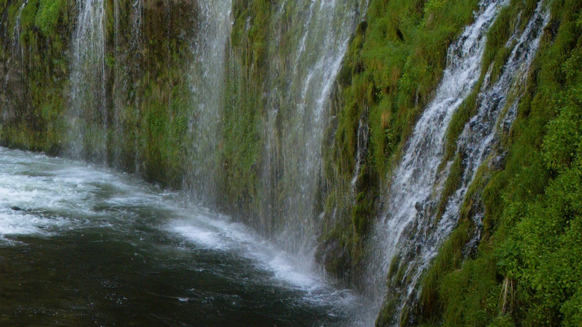 Water cascading down a mossy cliff at Mossbrae Falls
