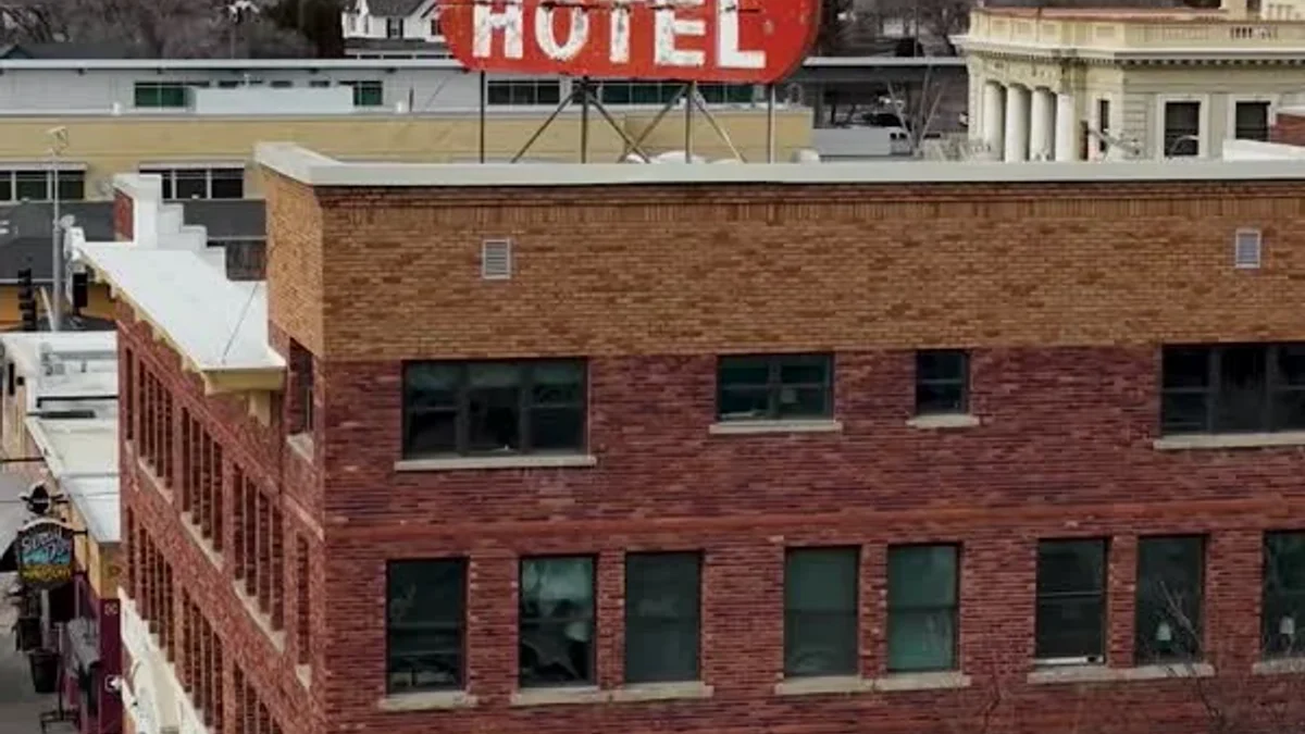 The red Pioneer Hotel sign tops a brick building in downtown Elko.