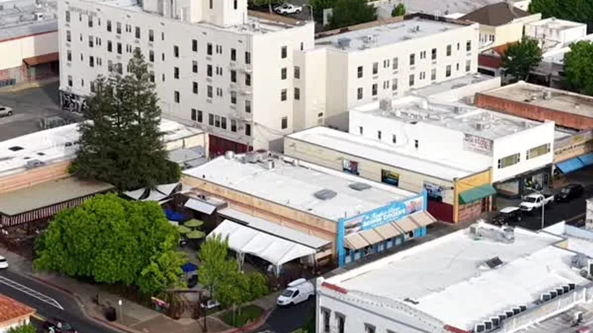 An aerial view shows downtown Oroville buildings, streets and surrounding hills.