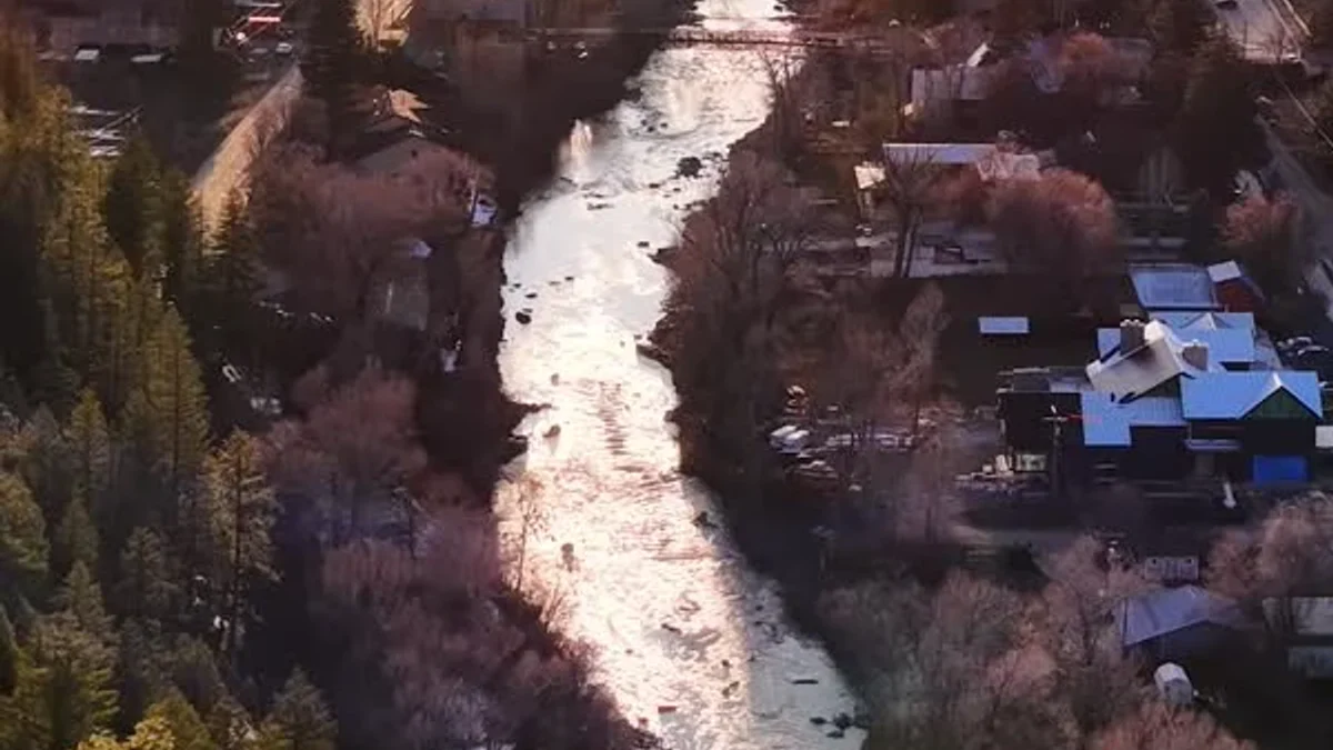 Low sun reflects along a river winding through Pagosa Springs.