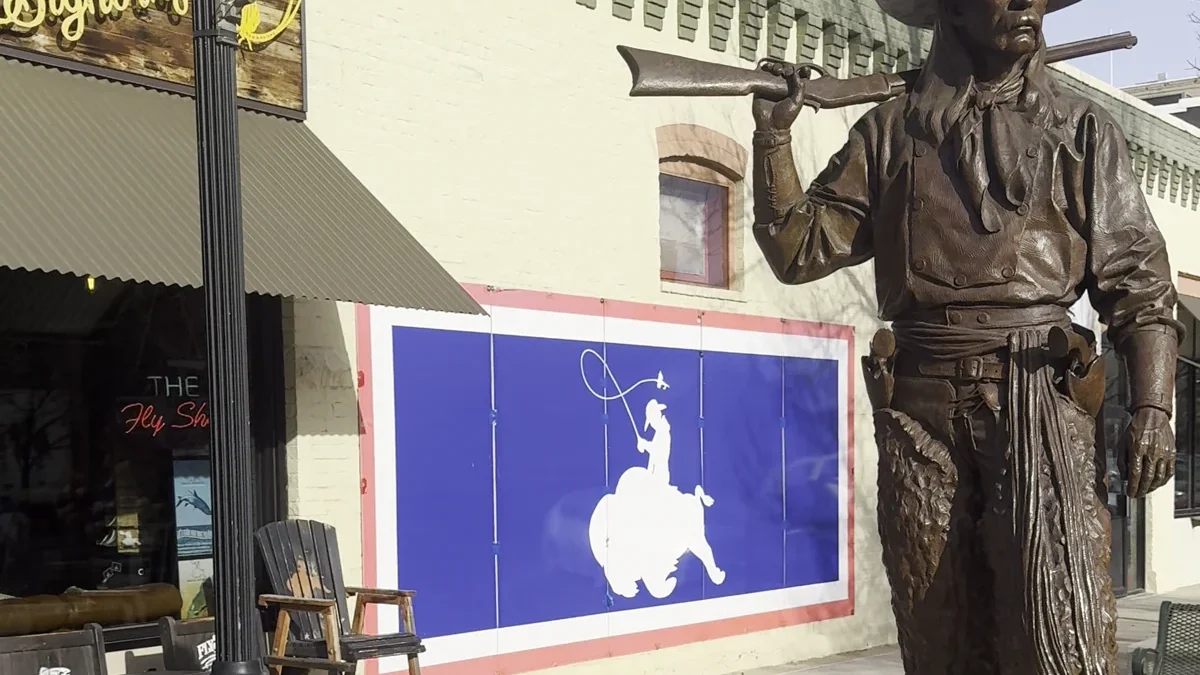 Cowboy sculpture beside a Sheridan storefront