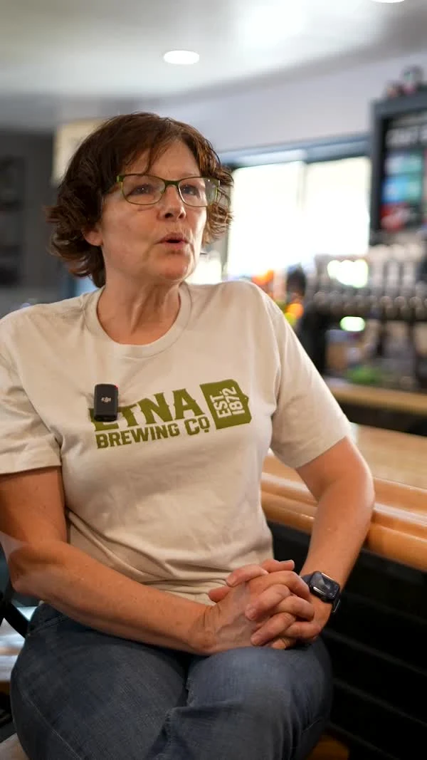 A participant wearing an Etna Brewing Co shirt sits inside the business.