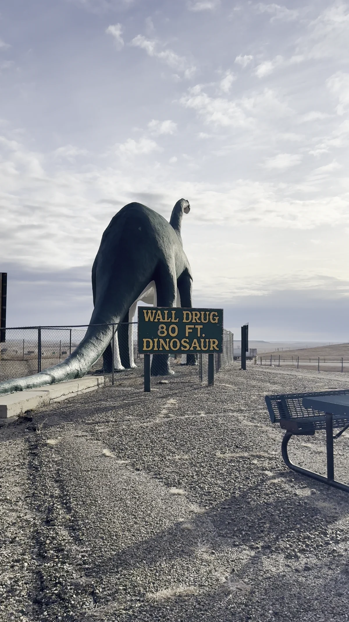 Large Wall Drug dinosaur and its roadside sign