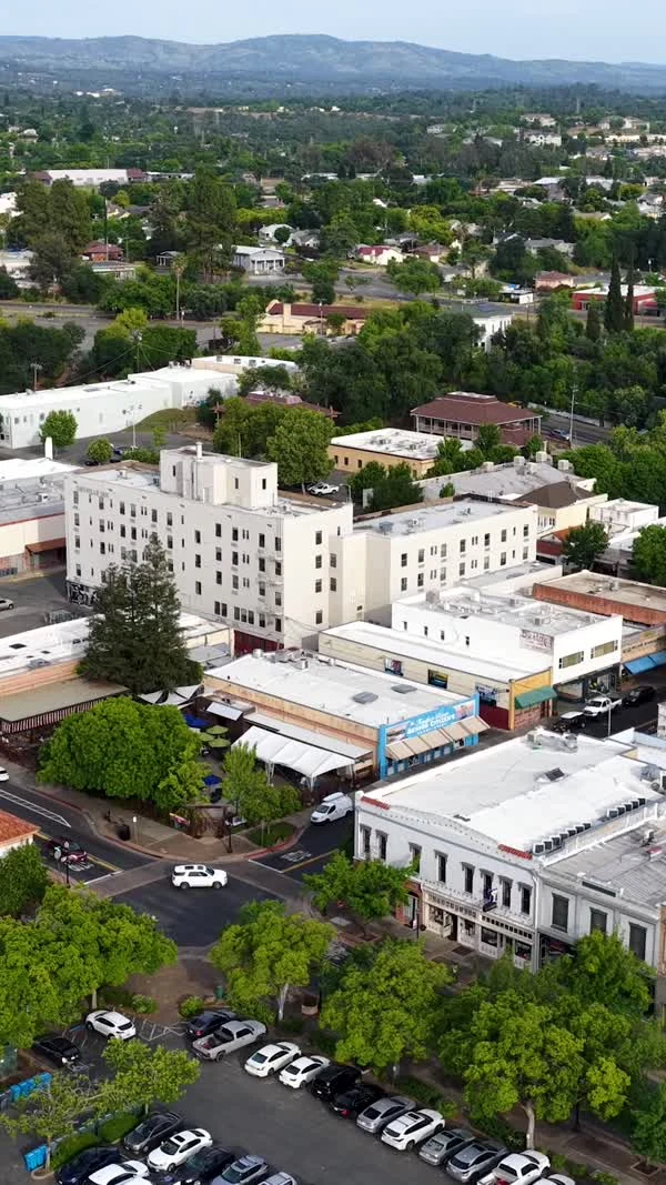 An aerial view shows downtown Oroville buildings, streets and surrounding hills.