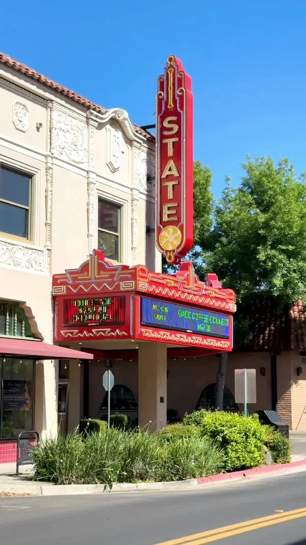 The red State Theatre sign and marquee rise above an Oroville sidewalk.
