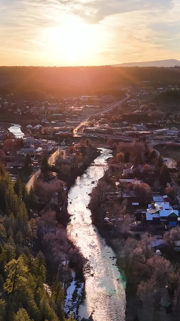 Low sun reflects along a river winding through Pagosa Springs.