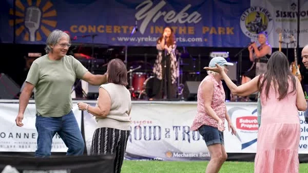 People dance in front of a live-music stage in Yreka.
